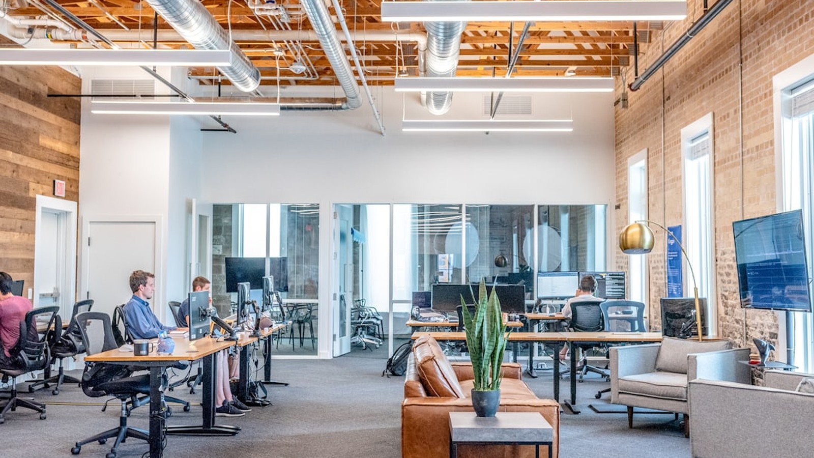 Marketer at a workstation surrounded by overlapping AI tool dashboards rendered in motion